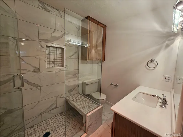 a bathroom with a sink toilet and shower