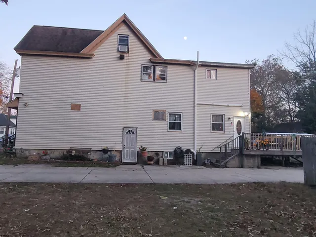 a view of house with backyard and sitting area