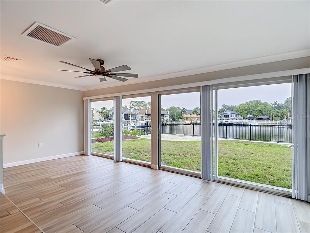 4536 Mitcher Road New Port Richey, FL 34652 - Photo 32 of 46 a view of an empty room with a large window and wooden floor
