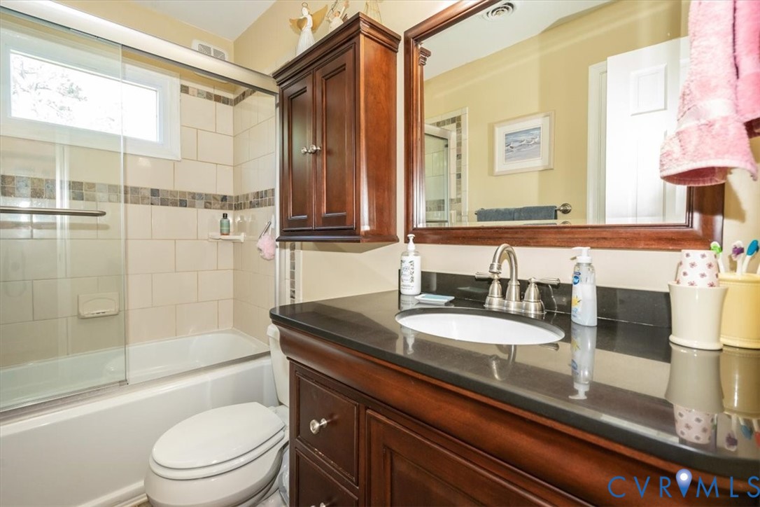 10712 Lunswood Road Chester, VA 23831 - Photo 21 of 31 Bathtub with sliding glass enclosure, tile accent,