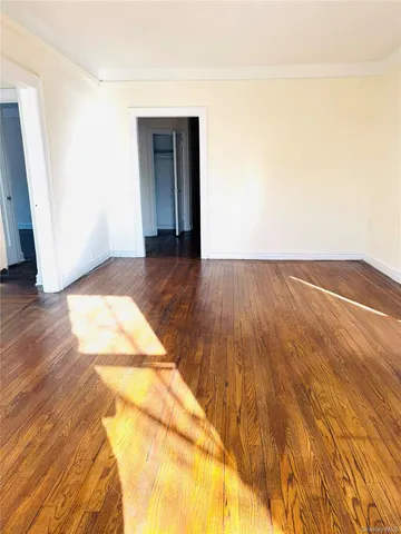 a view of an empty room and wooden floor