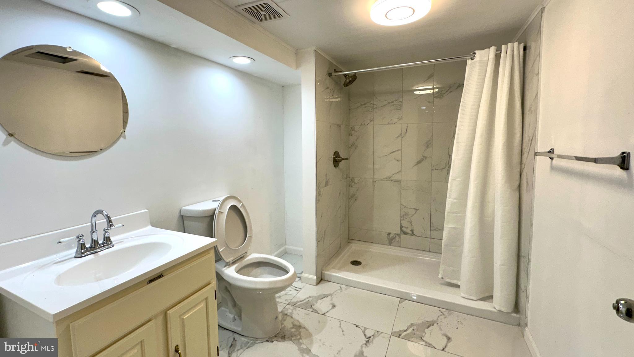 37 Othoridge Road Lutherville-Timonium, MD 21093 - Photo 22 of 38 a bathroom with a sink toilet and shower