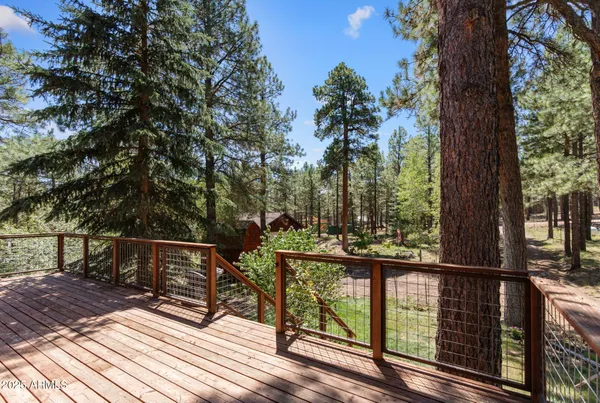 a view of a balcony with wooden floor and outdoor seating