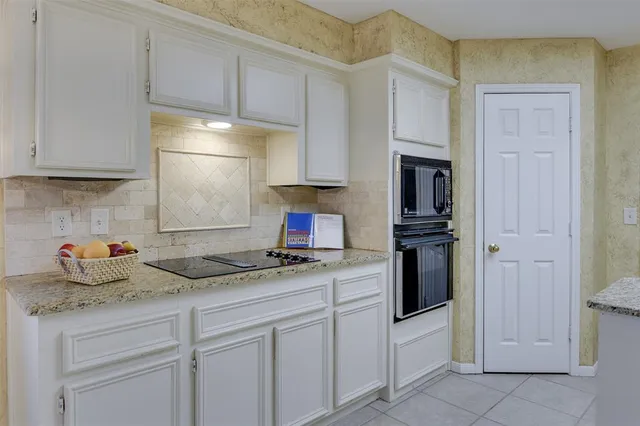 a kitchen with a sink a stove and a window