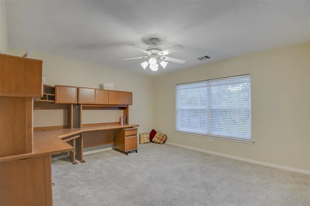 a spacious bedroom with a bed and a chandelier