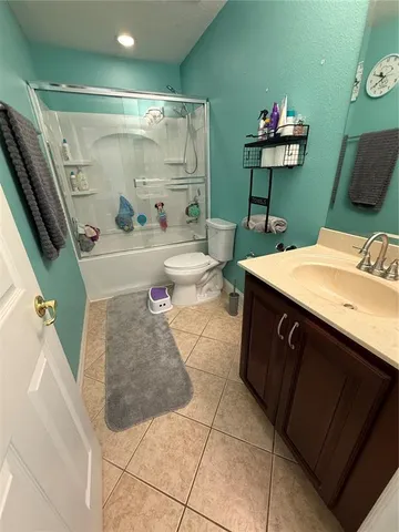 a bathroom with a sink a toilet and a shower