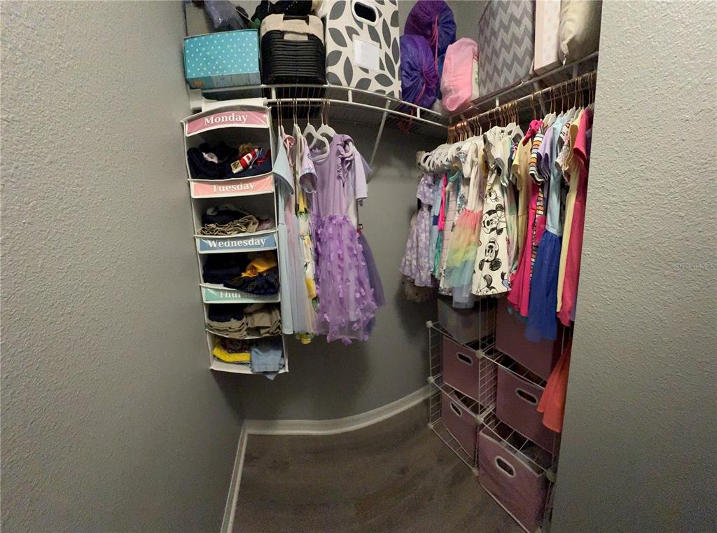 4780 Barbados Loop Clermont, FL 34711 - Photo 14 of 23 a view of walk in closet with clothes and shoes