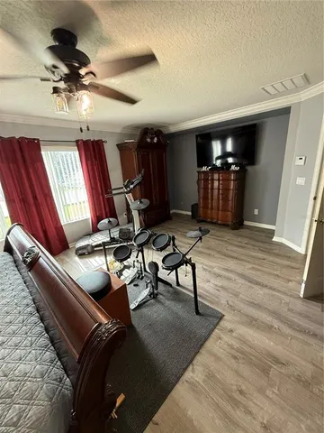 a living room with furniture gym equipment and a flat screen tv