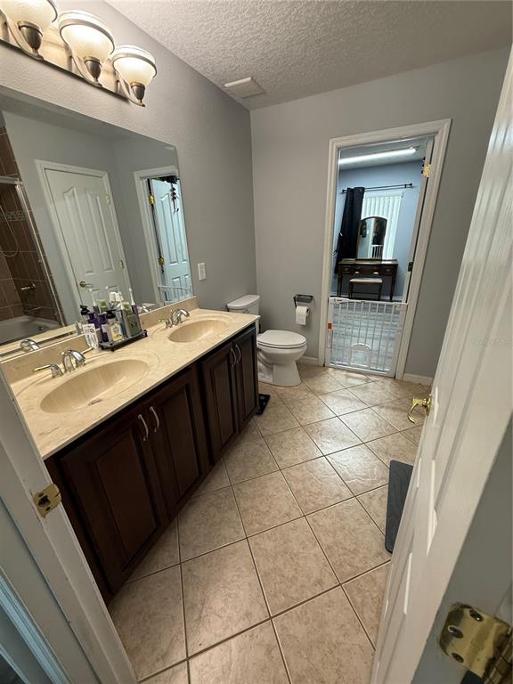 4780 Barbados Loop Clermont, FL 34711 - Photo 17 of 23 a bathroom with a sink a toilet and mirror