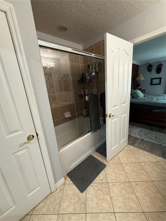 4780 Barbados Loop Clermont, FL 34711 - Photo 18 of 23 a bathroom with a tub shower and mirror