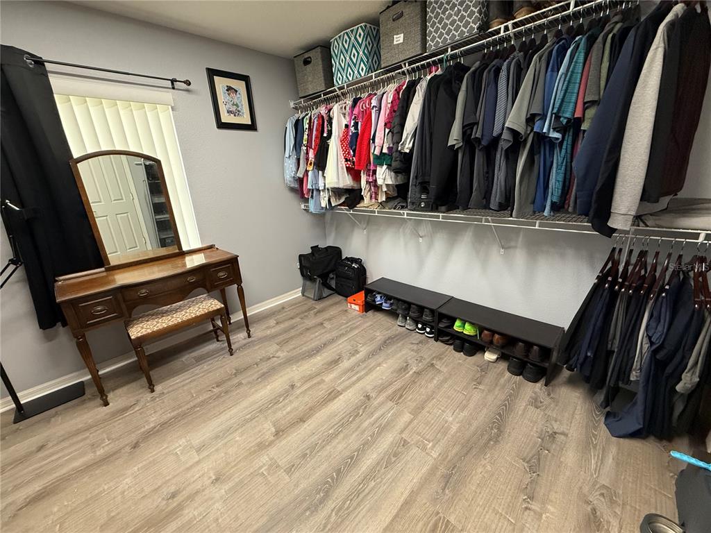 4780 Barbados Loop Clermont, FL 34711 - Photo 19 of 23 a view of walk in closet with clothes and shoes