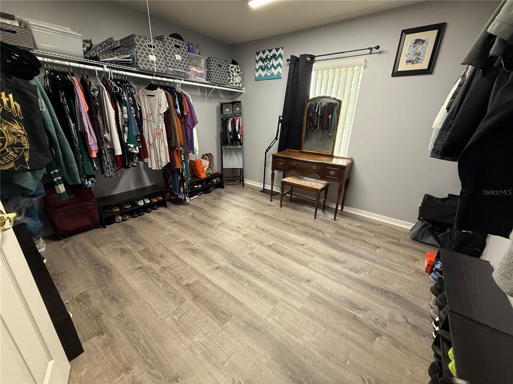 4780 Barbados Loop Clermont, FL 34711 - Photo 20 of 23 a view of walk in closet with clothes and shoes