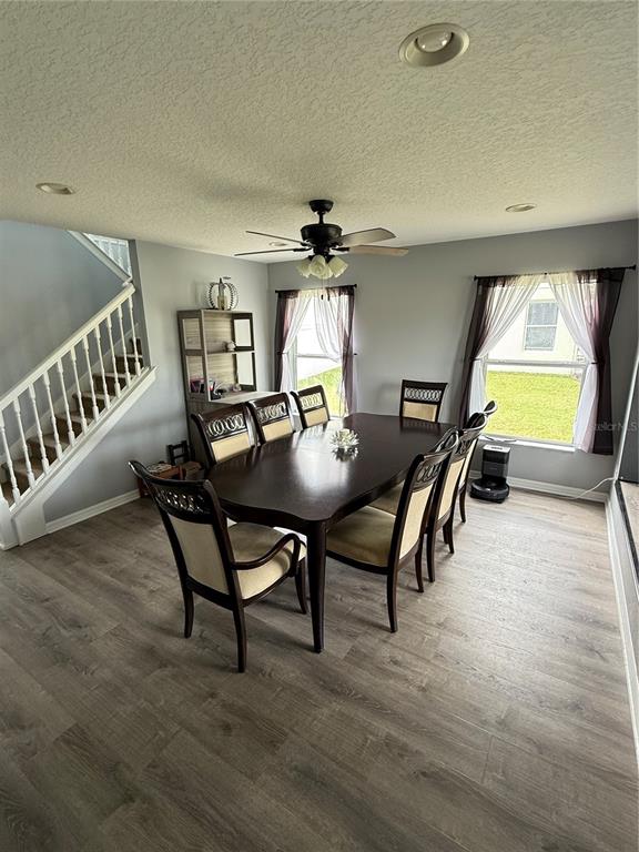 4780 Barbados Loop Clermont, FL 34711 - Photo 2 of 23 a view of a dining room with furniture window and wooden floor