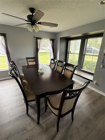 a view of a dining room with furniture window and outside view