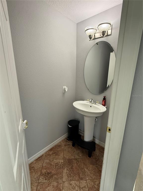 4780 Barbados Loop Clermont, FL 34711 - Photo 7 of 23 a bathroom with a sink toilet and a mirror