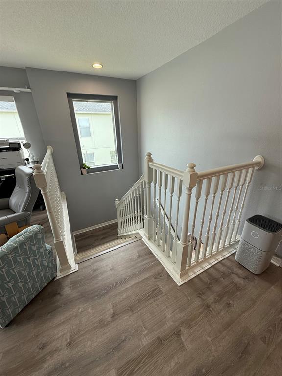4780 Barbados Loop Clermont, FL 34711 - Photo 8 of 23 a view of an empty room with wooden floor and a window