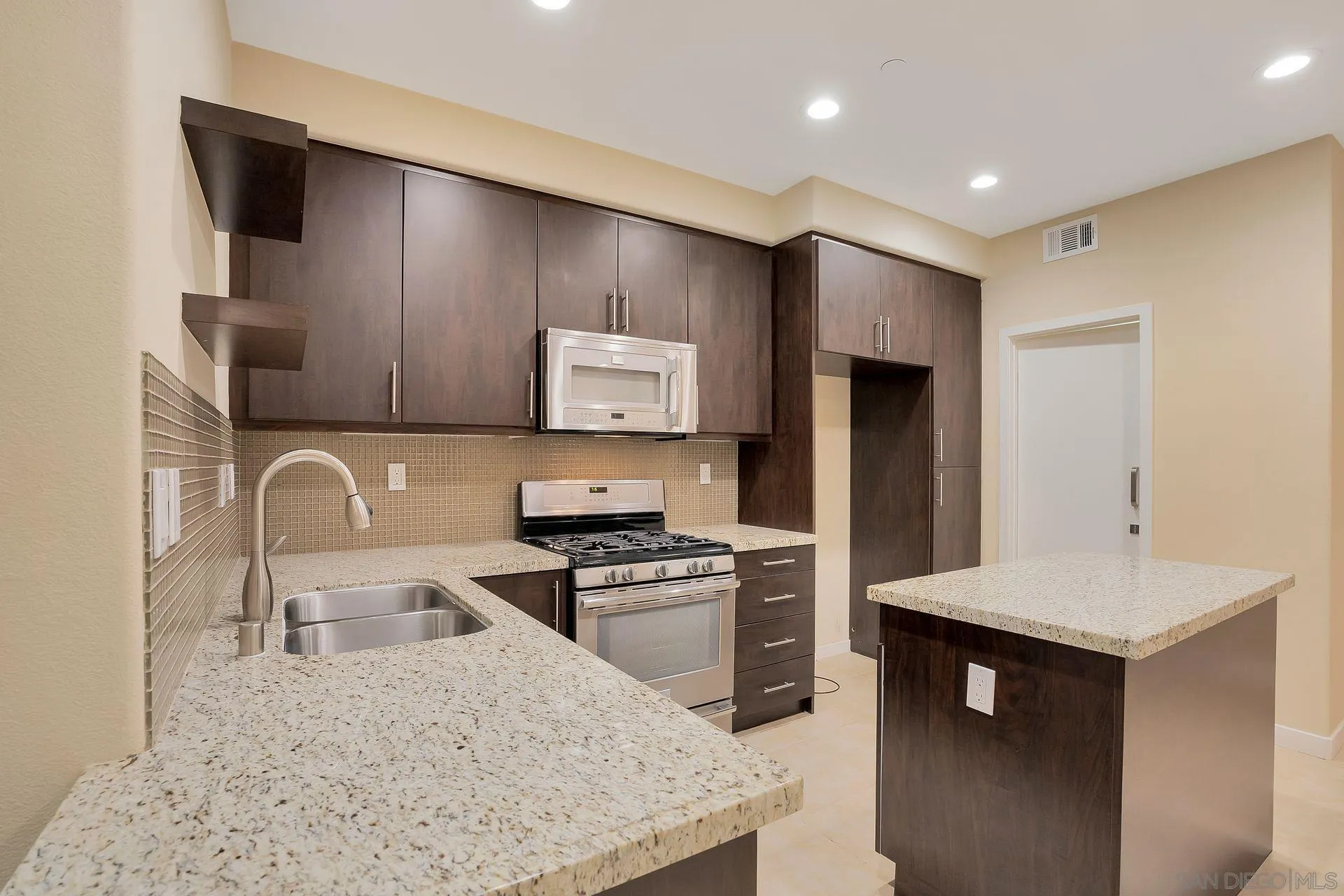 2236 Indus Way San Marcos, CA 92078 - Photo 11 of 30 a kitchen with stainless steel appliances granite countertop a sink stove and refrigerator