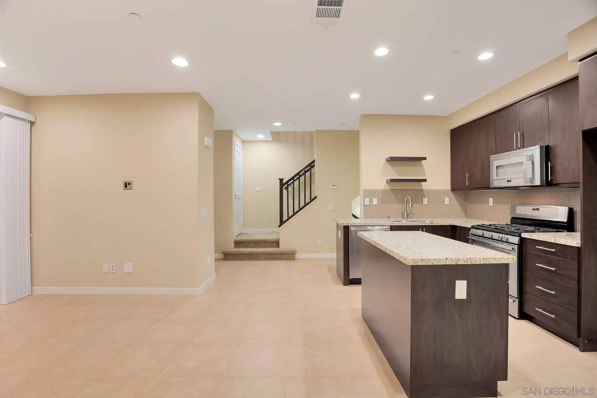 2236 Indus Way San Marcos, CA 92078 - Photo 15 of 30 a kitchen with stainless steel appliances granite countertop a stove a sink and a refrigerator
