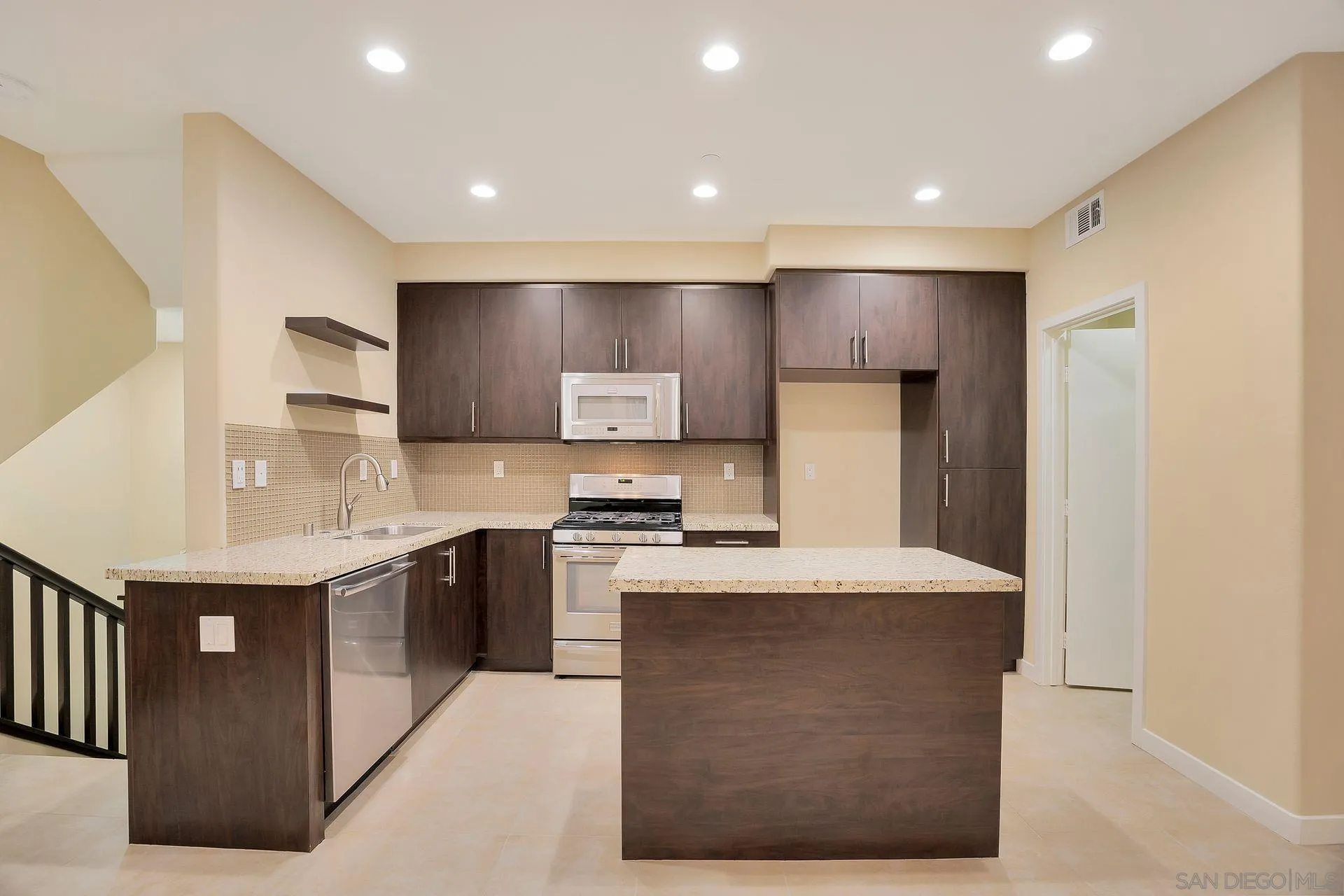2236 Indus Way San Marcos, CA 92078 - Photo 8 of 30 a kitchen with stainless steel appliances granite countertop a stove a sink a refrigerator and a refrigerator