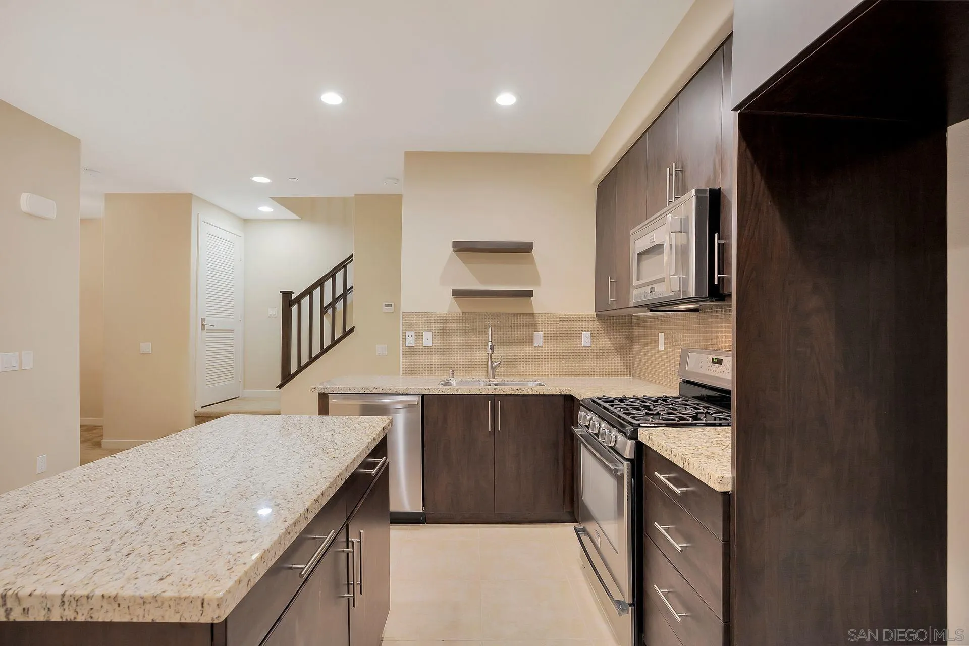 2236 Indus Way San Marcos, CA 92078 - Photo 9 of 30 a kitchen with stainless steel appliances granite countertop a sink a stove and a refrigerator