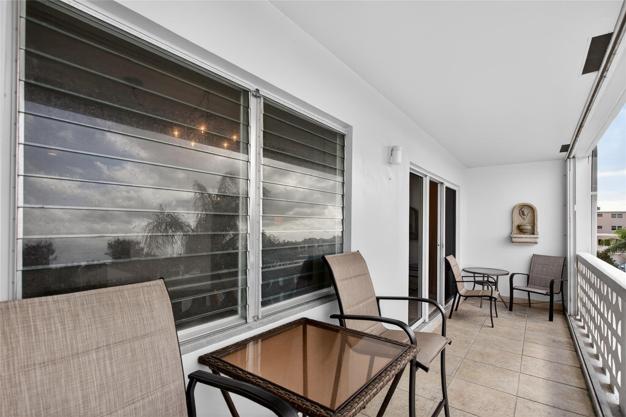 1001 North Riverside Drive, Unit 305 Pompano Beach, FL 33062 - Photo 20 of 44 a view of a livingroom with lounge chair and a window