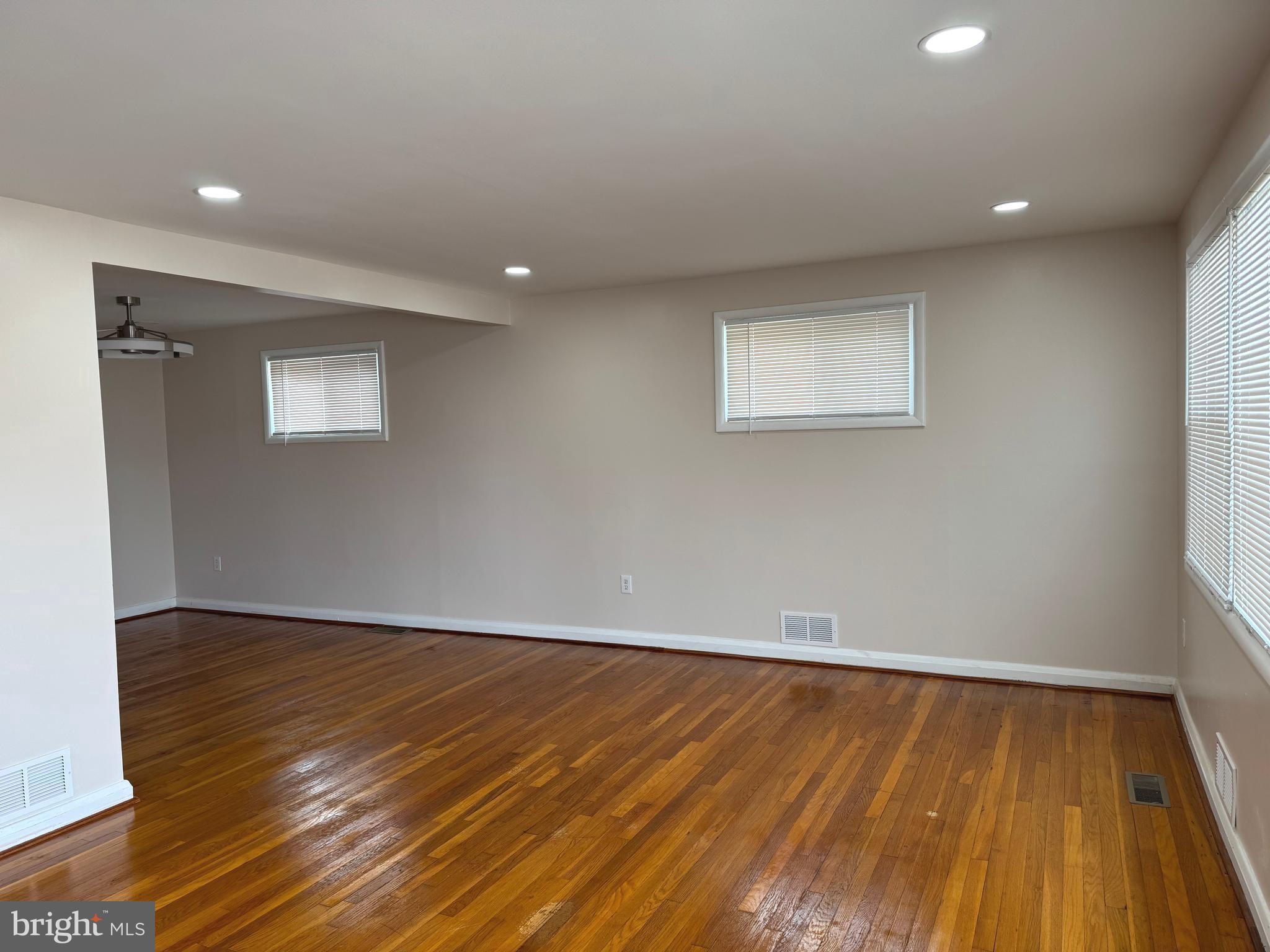 609 Wallerson Road Baltimore, MD 21228 - Photo 12 of 15 a view of an empty room with wooden floor and a window