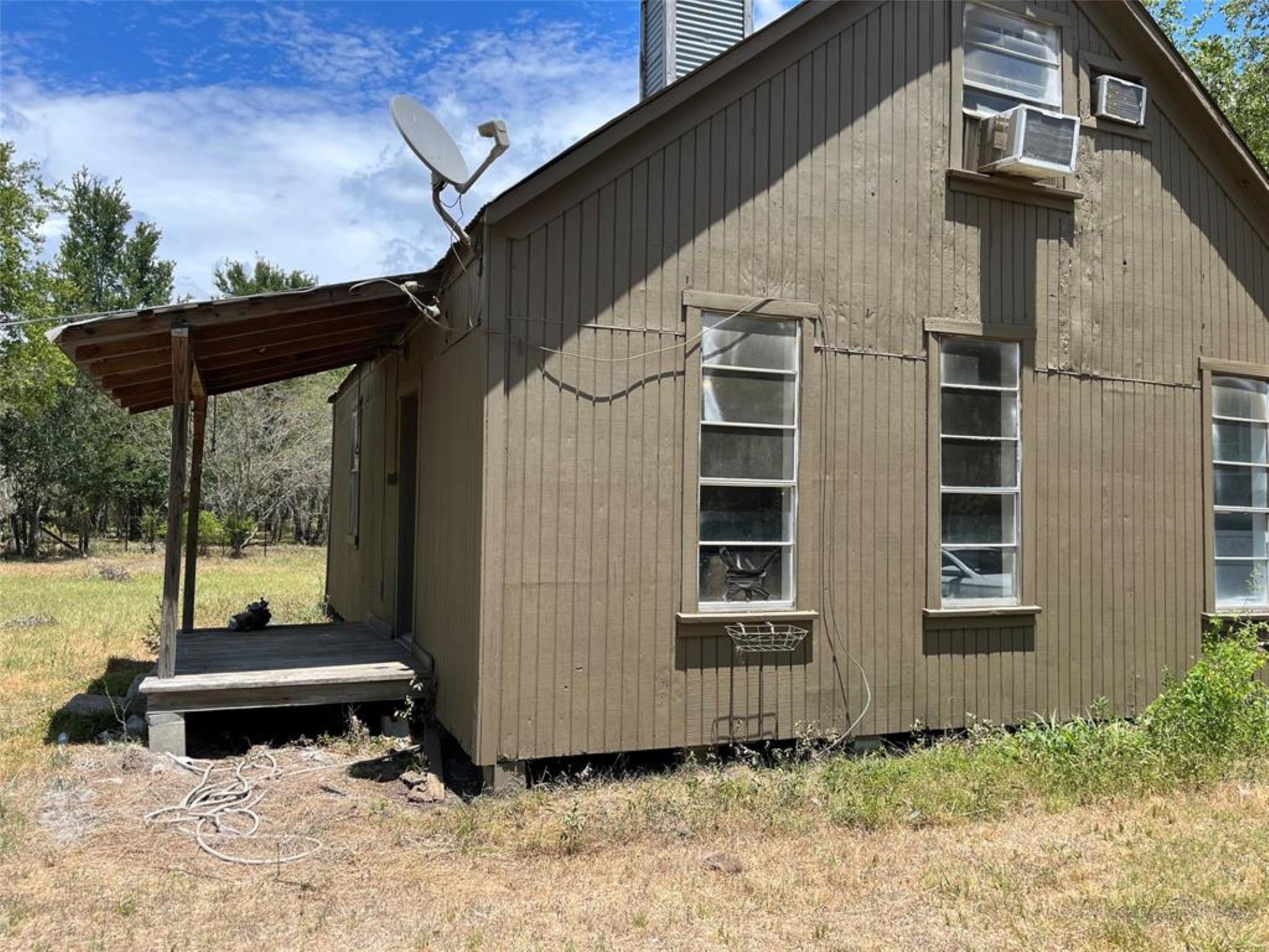 11712 FM 1458 Road Sealy, TX 77474 - Photo 3 of 13 a backyard of a house with wooden fence and a bench