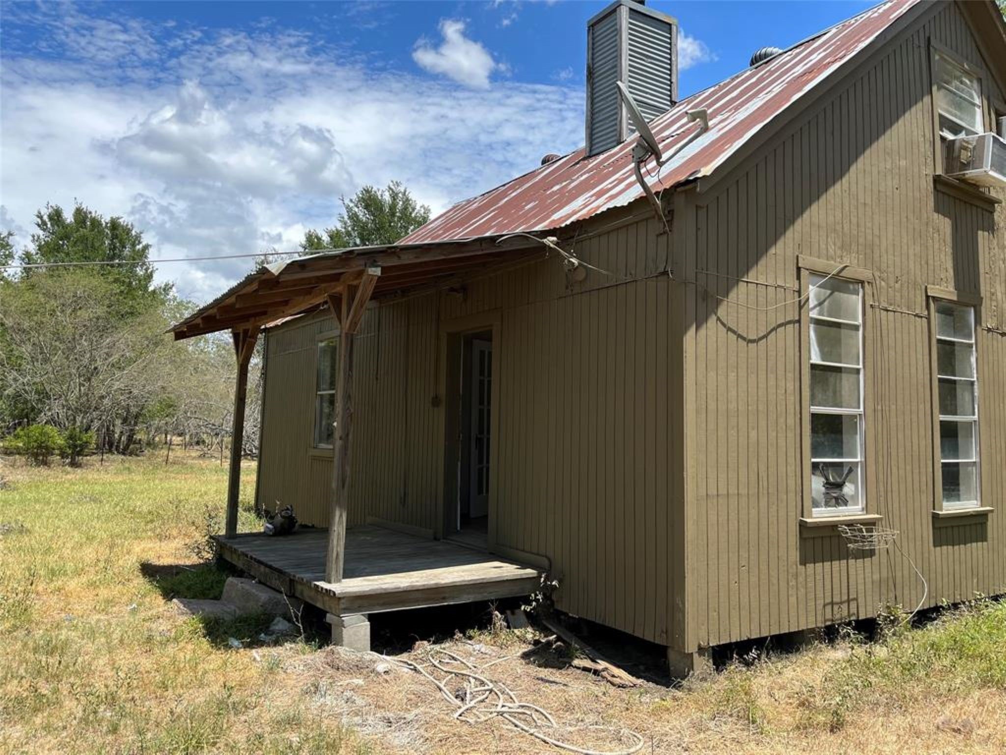 11712 FM 1458 Road Sealy, TX 77474 - Photo 3 of 13 a backyard of a house with wooden fence next to a yard