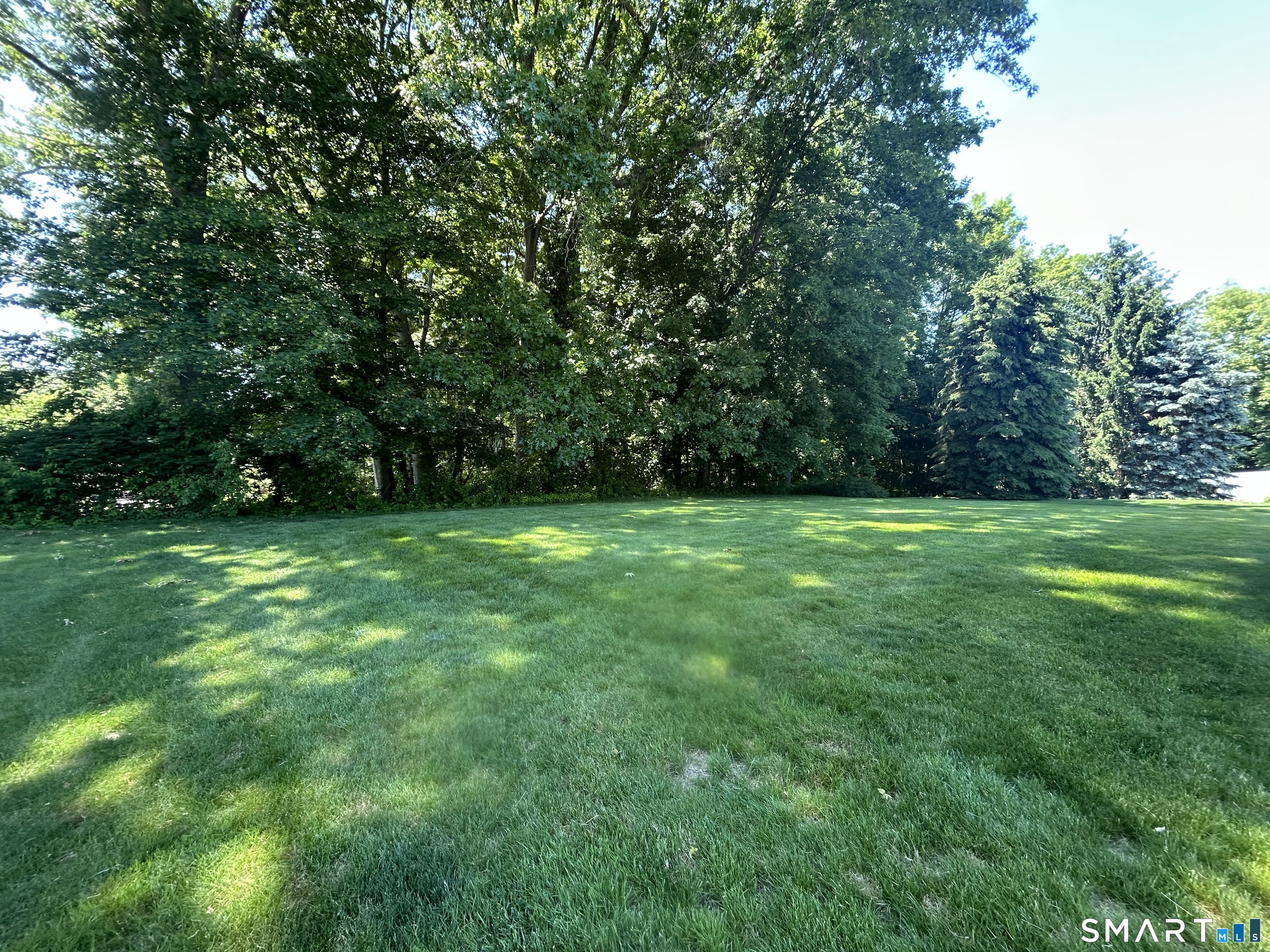 13 Walnut Lane Wallingford, CT 06492 - Photo 26 of 27 a view of green field with trees in the background