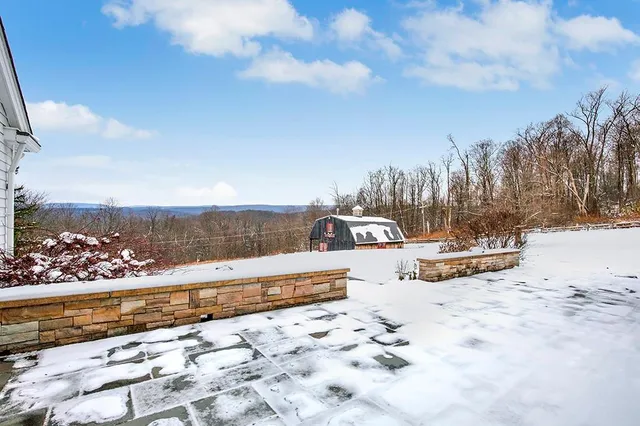 a view of a hallway with wooden floor and a living room