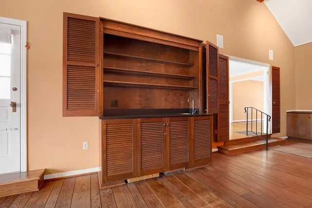 a bedroom with a bed and a flat tv screen on dresser