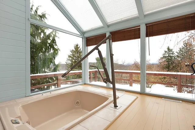 a view of a swimming pool with an outdoor seating and a lake view