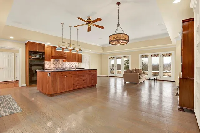 a living room with furniture and kitchen view