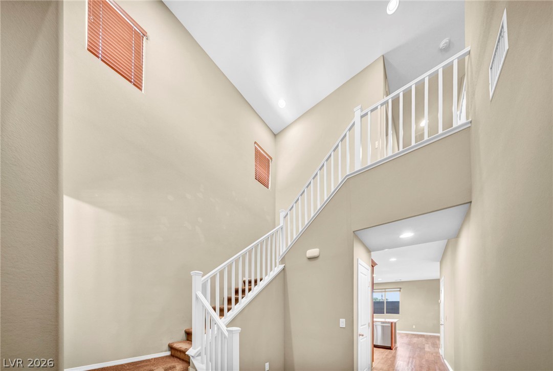 5014 Fiery Sky Ridge Street Las Vegas, NV 89148 - Photo 4 of 21 A grand two-story entry with a graceful staircase and soaring ceilings invites you further inside.
