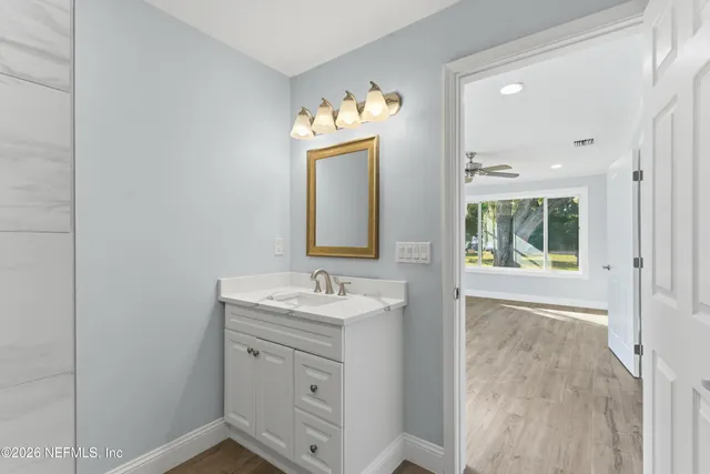 a bathroom with a sink mirror and vanity