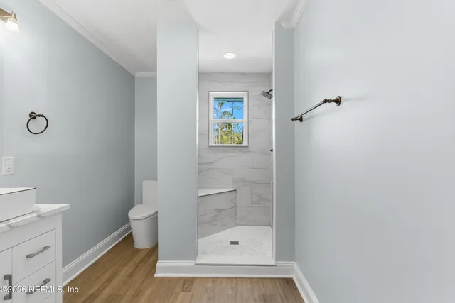 a bathroom with a toilet and a shower