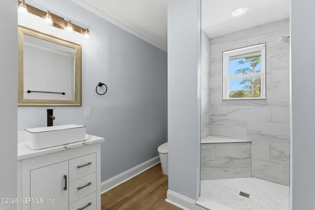 a bathroom with a shower sink and mirror