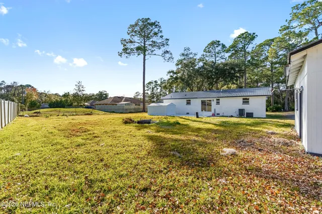 a house view with swimming pool and yard