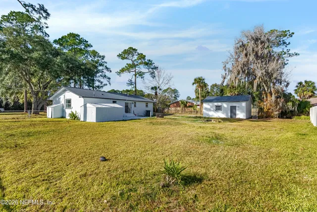 a house view with swimming pool in front of it