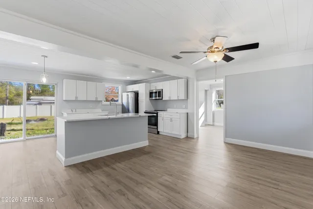 a view of kitchen with cabinets and wooden floor