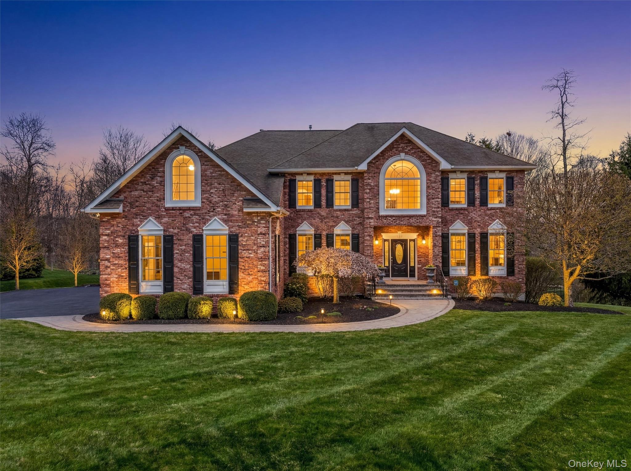 Welcome to your forever estate—an extraordinary and exceedingly rare offering. One of just five of Lennar’s coveted Luxury Sinclair models ever built in the prestigious Legends neighborhood, this exceptional custom Colonial stands as the undisputed crown jewel of the community, located just 65 miles from Manhattan and offering a seamless blend of refined luxury and tranquil retreat. Gracefully set on 1.28 acres of impeccably manicured grounds, the property delivers a level of privacy and exclusivity seldom found, framed by picturesque, tree-lined streets and showcasing unforgettable curb appeal with mature landscaping and a newly expanded, grand-scale driveway that creates a truly impressive arrival experience. Every detail of this residence has been thoughtfully curated to elevate daily living, balancing elegance, comfort, and functionality, making it far more than a home—it is a private sanctuary, a statement of prestige, and a once-in-a-lifetime opportunity to own a distinguished property in one of the are