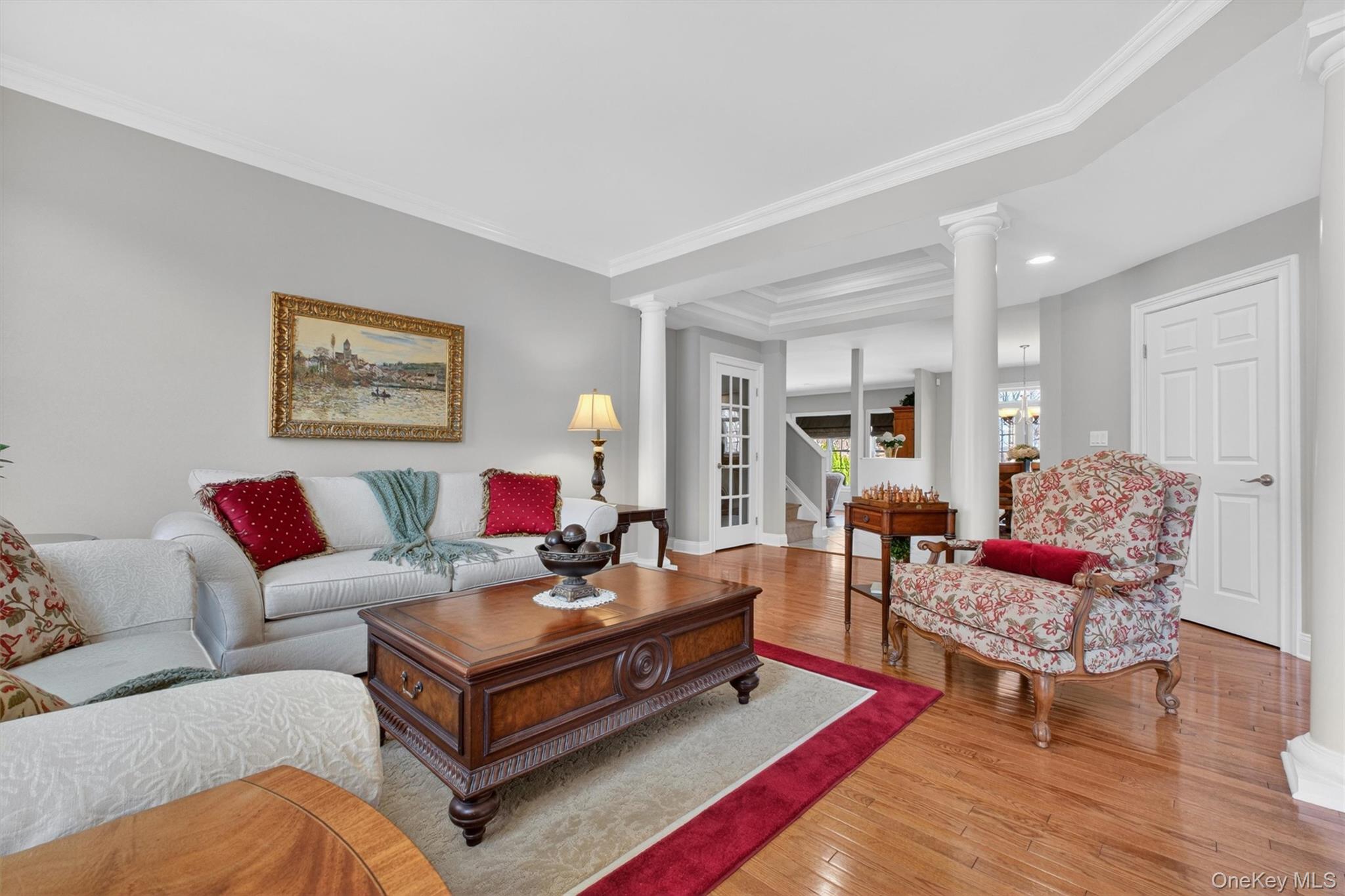 196 Country Club Road Hopewell Junction, NY 12533 - Photo 49 of 50 From the dramatic two-story reception hall foyer, rich hardwood floors and elegant architectural detailing set the tone for a grand yet inviting open floor plan. The space flows effortlessly to the left into the formal living room and continues seamlessly into the sun-filled kitchen, expansive eat-in area, and spectacular family room—creating a true entertainer’s dream layout. Just beyond, the design transitions naturally toward the oversized lavatory, mudroom area, and garage entrance, offering both convenience and functionality. Wide, open, and thoughtfully designed, this portion of the home also presents an incredible opportunity to customize the mudroom of your dreams, with ample space for built-ins, benches, cubbies, and organized storage—perfectly blending everyday practicality with refined style.