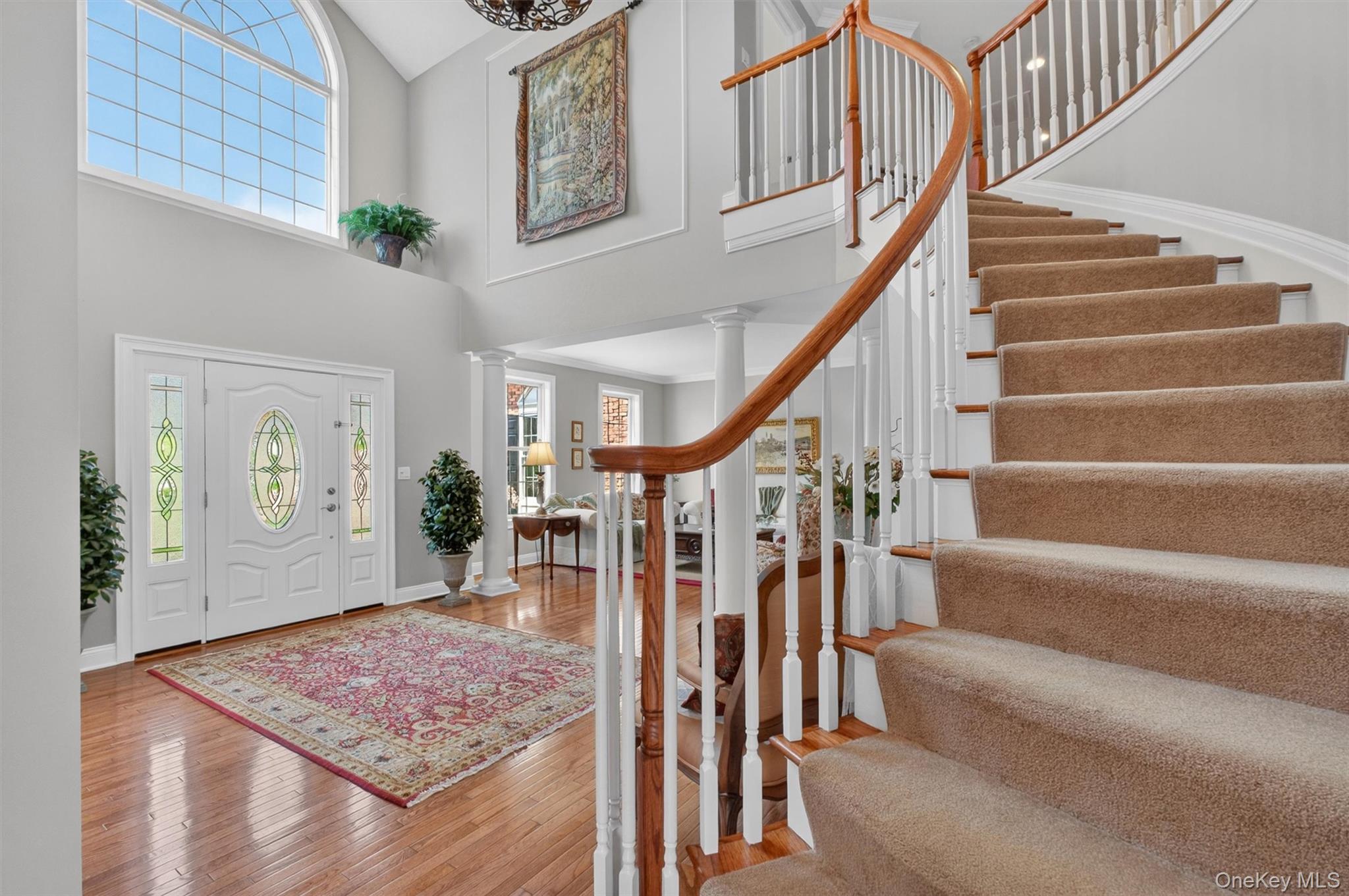 196 Country Club Road Hopewell Junction, NY 12533 - Photo 15 of 50 Designed in the style of a grand reception hall, the breathtaking upper-level gallery overlooks the dramatic two-story foyer below, creating a show-stopping architectural centerpiece. As you ascend, this stunning loft-like catwalk becomes the heart of the second floor, effortlessly connecting the luxurious primary suite, a private junior suite with its own full bath, and a spacious prince/princess suite that shares a beautifully appointed Jack-and-Jill bath with Bedroom #4. Completing this exceptional level is a full second-floor laundry suite and access to a second staircase, adding both elegance and everyday convenience. Radiating light, scale, and sophistication, this dazzling space perfectly captures the grandeur and thoughtful design of the home.