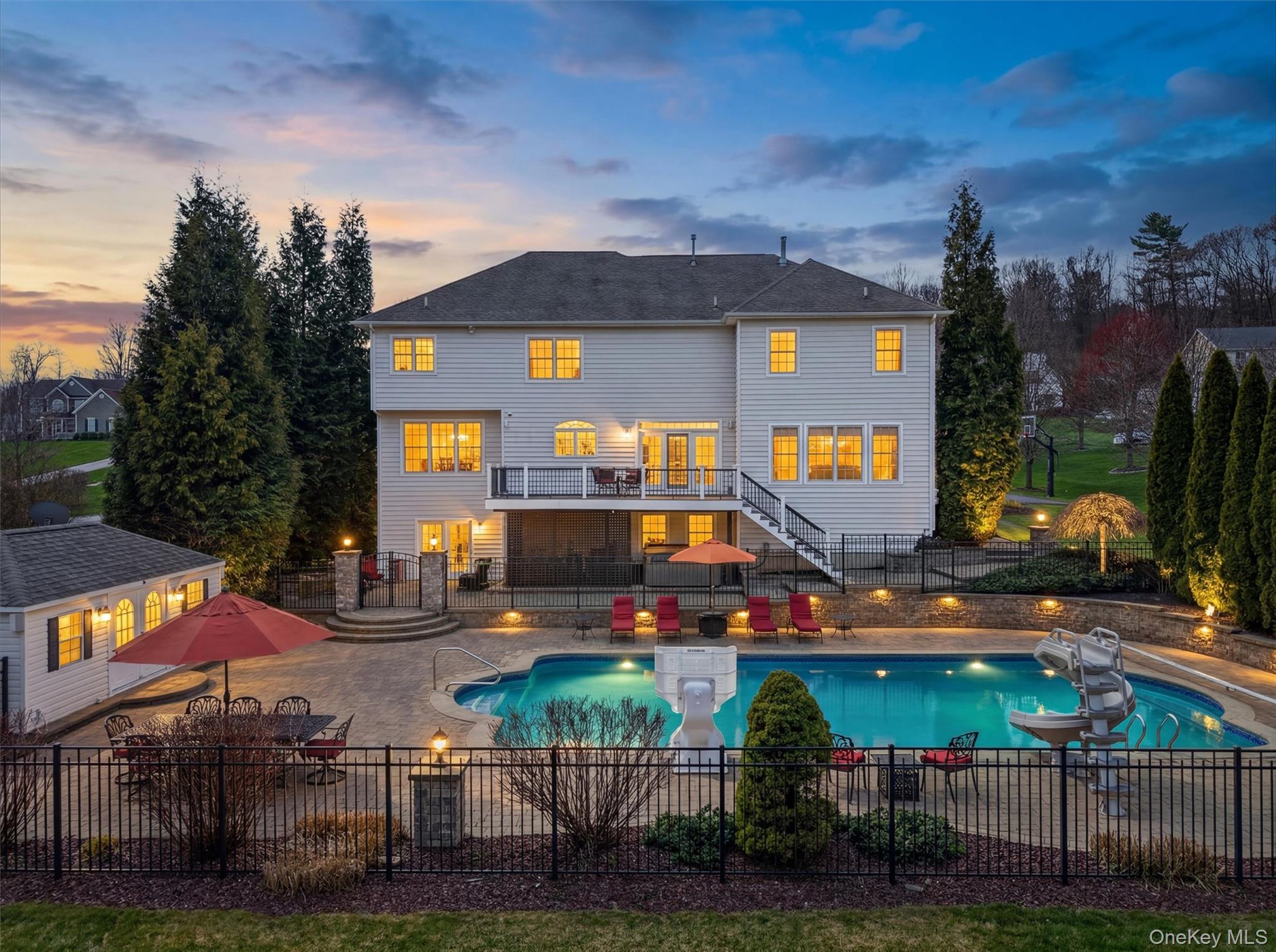 196 Country Club Road Hopewell Junction, NY 12533 - Photo 2 of 50 Start living like a legend in this Shangri-La crown jewel, perched at the highest point of the prestigious Legends community. Set on 1.28 private acres just 65 miles from Manhattan, this 6,200+ sq ft, 4-bedroom, 4.5-bath Lennar Luxury estate delivers a true resort-style lifestyle with breathtaking panoramic Hudson Valley views. Walls of oversized windows flood the home with natural light, showcasing rolling hills and treetops from the main living spaces, while an expansive deck offers the perfect setting for sunrise coffee or sunset entertaining. The backyard is a private oasis, featuring a stunning 22' x 48' in-ground pool with full automation, a 12' x 20' pool house, and a fully integrated outdoor sound system. With unmatched privacy, elegant design, and exceptional indoor-outdoor flow, this one-of-a-kind estate is the ultimate retreat—where luxury living meets everyday escape