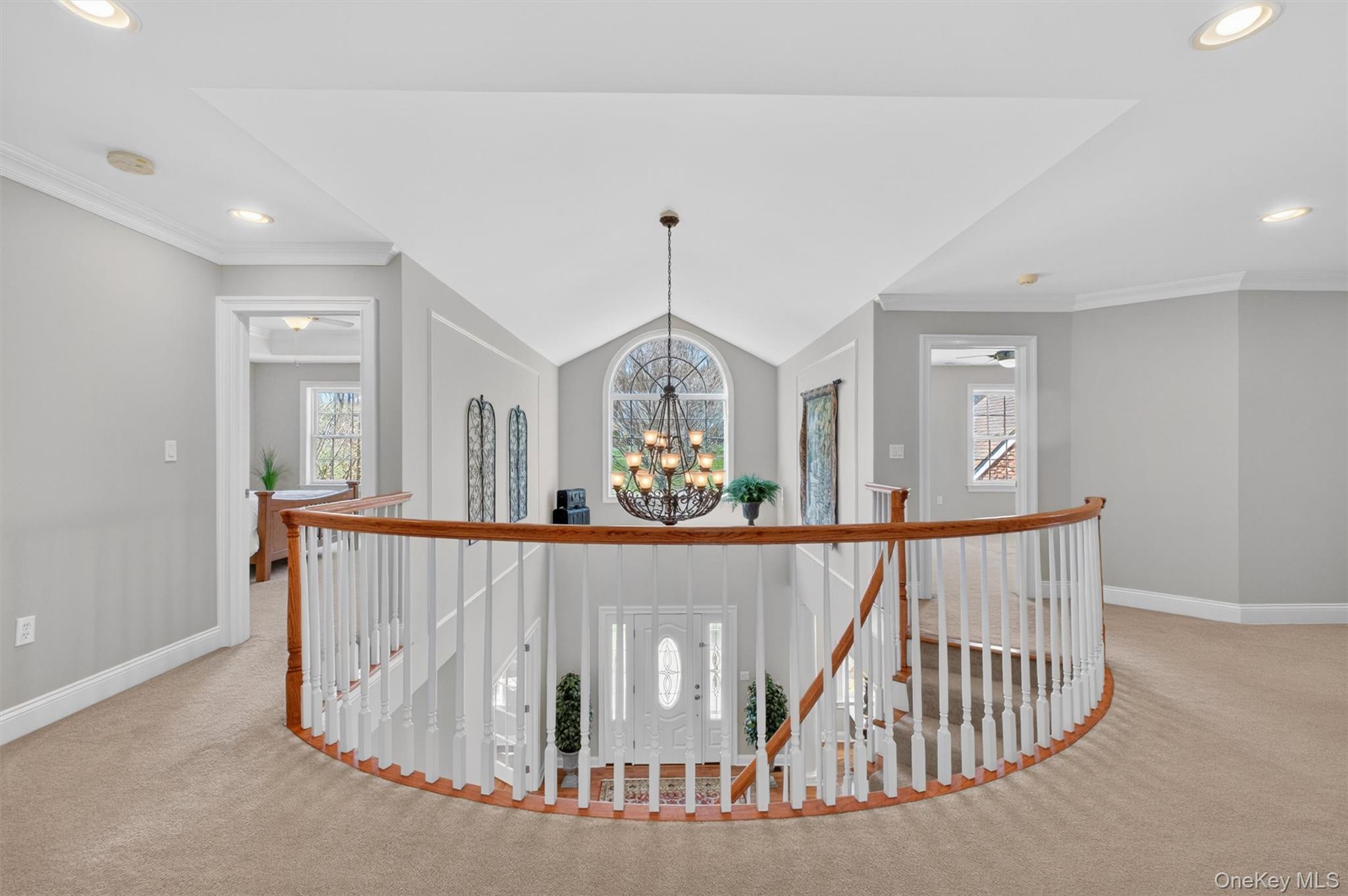 196 Country Club Road Hopewell Junction, NY 12533 - Photo 22 of 50 Designed in the style of a grand reception hall foyer, the impressive upper-level gallery overlooks the dramatic two-story family room below and creates a stunning architectural centerpiece within the home. Accessed by either of the home’s two elegant staircases, this expansive loft-like hallway serves as the central connection point for the entire second floor. From this dramatic vantage point, the gallery seamlessly links the private primary suite and luxurious bath to three additional bedrooms, two full baths, a separate laundry room, and a charming built-in window seat—an inviting nook perfect for reading or relaxing. Thoughtfully designed to enhance the home’s open flow, this sophisticated reception hall adds both elegance and functionality while showcasing the home’s remarkable scale and design.