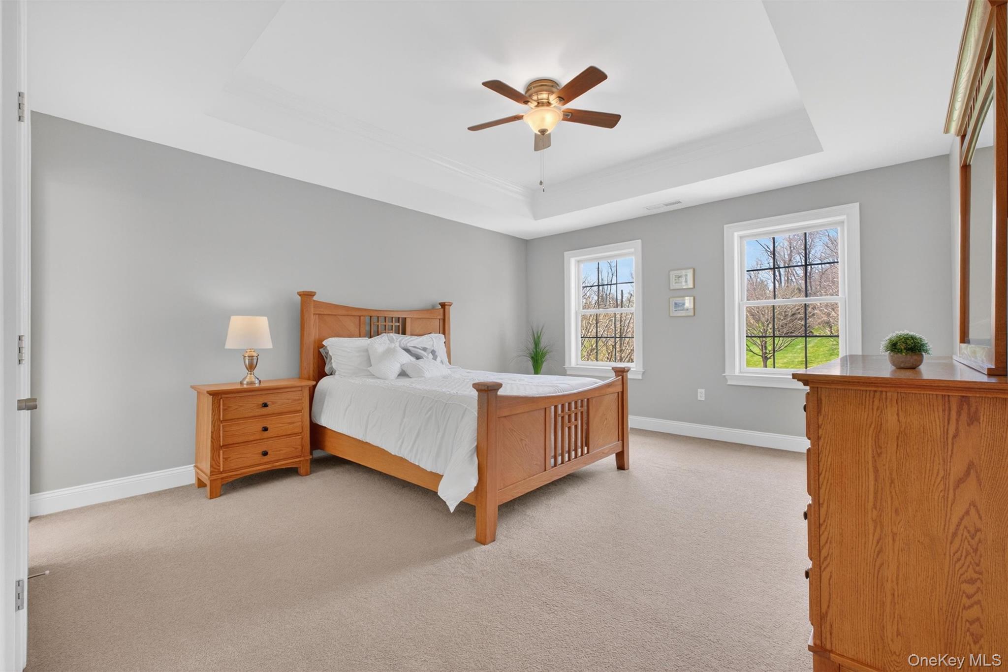 196 Country Club Road Hopewell Junction, NY 12533 - Photo 23 of 50 Just beyond the primary suite is a charming junior suite (bedroom #3), thoughtfully designed with its own private full bath for exceptional comfort and privacy. This inviting bedroom features a spacious walk-in closet and has been freshly painted in a soft, soothing palette that creates a calm and welcoming atmosphere. The ensuite bath is beautifully finished in an exceptionally bright and neutral palette, featuring crisp white ceramic tile, a spacious vanity topped with elegant St. Cecilia granite, White tiled tub and a fresh, timeless design that feels both clean and sophisticated. Perfect for guests, extended family, or anyone seeking additional privacy, this suite offers a wonderful blend of elegance, convenience, and everyday functionality.