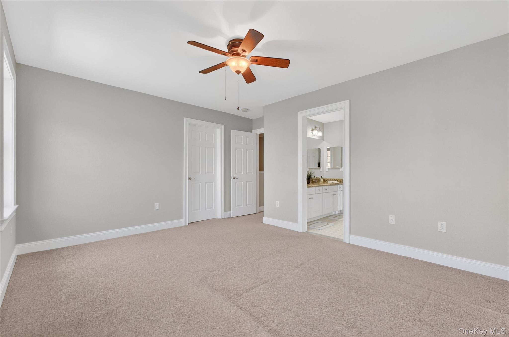 196 Country Club Road Hopewell Junction, NY 12533 - Photo 25 of 50 Tucked away on the upper level, this spacious 14' x 15' prince or princess suite (bedroom#2) offers the perfect blend of comfort, privacy, and charm. Generously sized and filled with natural light, the room features a large walk-in closet and direct access to the adjoining Jack-and-Jill bath, creating a private suite-like feel. Thoughtfully designed with ample space for a sitting area, study nook, or additional furnishings, this inviting bedroom is ideal for family or guests and provides a beautiful retreat all its own.