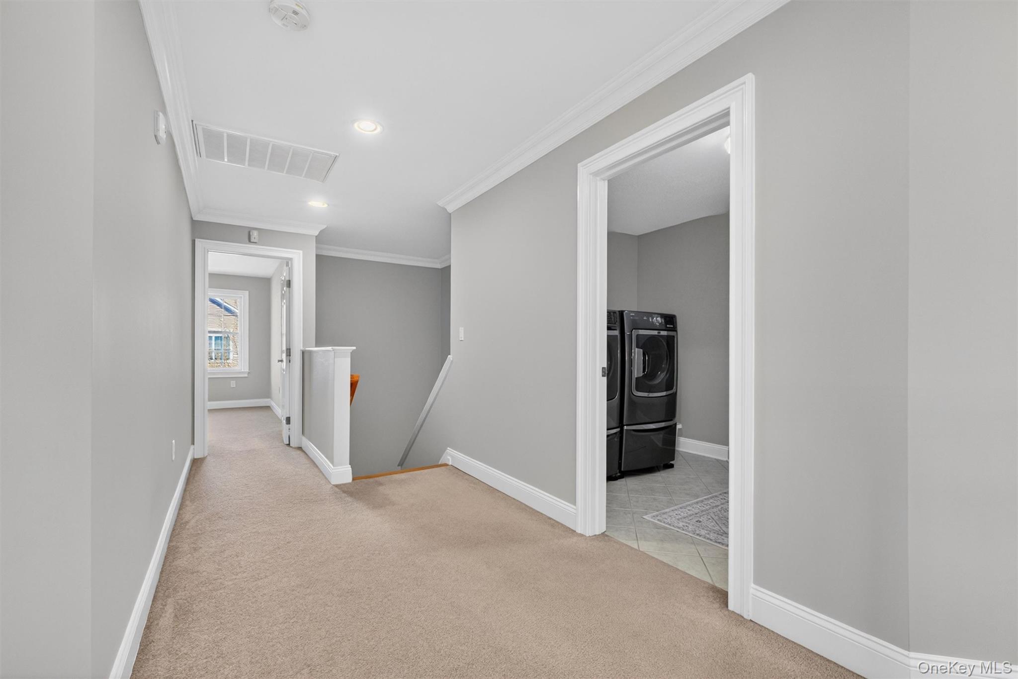 196 Country Club Road Hopewell Junction, NY 12533 - Photo 28 of 50 Beyond the dramatic two-story grand foyer, a distinctive second staircase adds both charm and convenience to this exceptional home. Gracefully tucked between the kitchen, living room, and rear hallway, this architectural feature enhances the home’s flowing layout while providing a second point of access to the upper level.