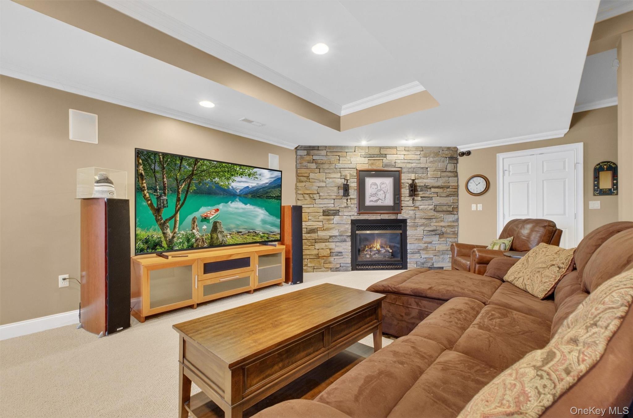 196 Country Club Road Hopewell Junction, NY 12533 - Photo 32 of 50 The recently finished basement is a spectacular retreat designed for both entertaining and everyday enjoyment. Anchored by a stately stone custom gas fireplace—the home’s third—this expansive space offers warmth and character throughout. From the billiards area, you’ll enjoy a full view of the open-concept layout, which flows seamlessly into a cozy media and living zone, perfect for movie nights or watching the big game. A beautifully crafted wet bar featuring rich teak finishes and stained-glass accents adds a touch of artistry, while the impressive 800-bottle temperature- and humidity-controlled wine cellar is a true standout for collectors. Complete with a fourth full bath and pre-wired for a 7.2 surround sound system, this incredible lower level is a dream space for both kids and adults, blending luxury, comfort, and entertainment in one exceptional setting.