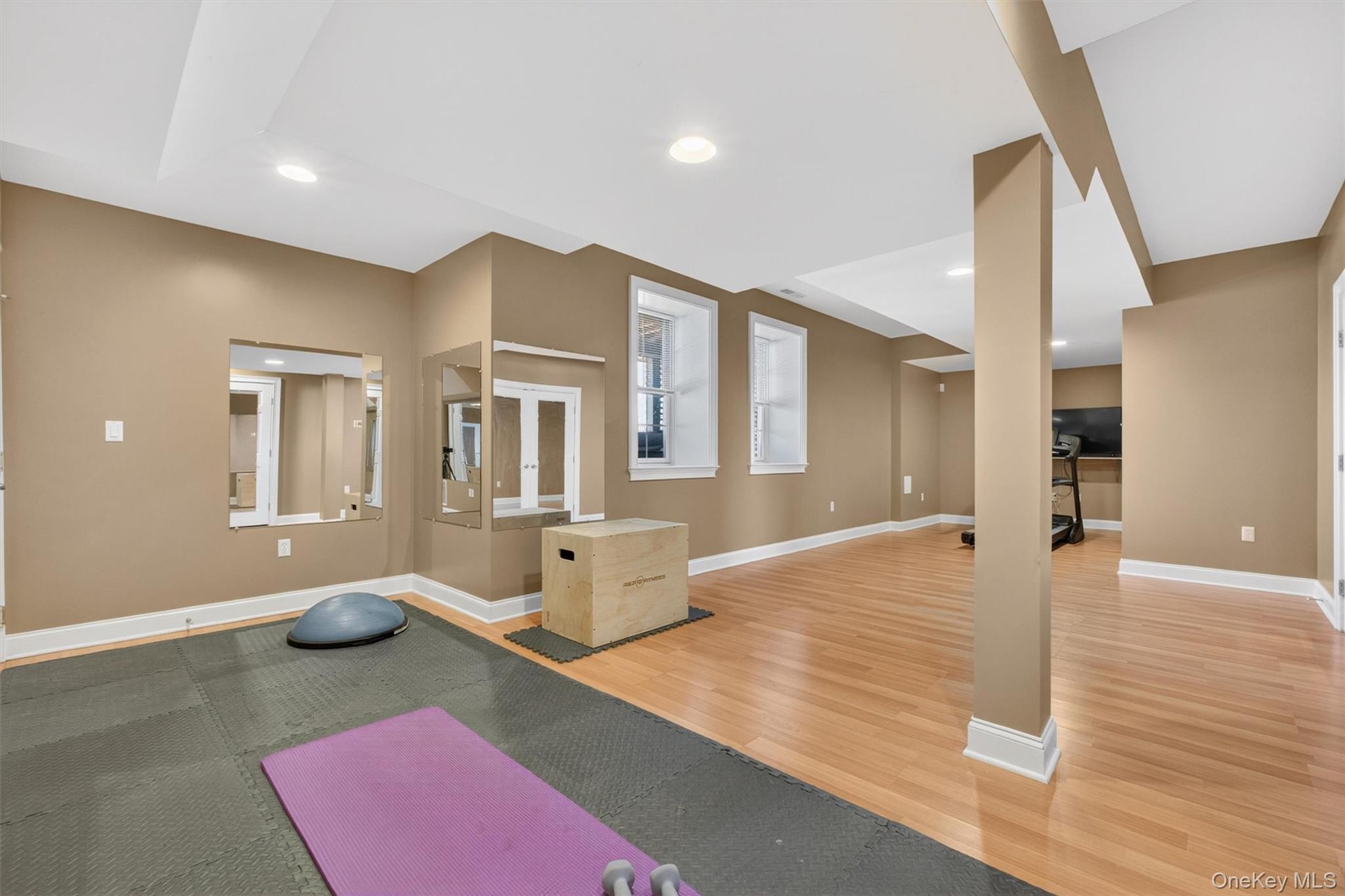 196 Country Club Road Hopewell Junction, NY 12533 - Photo 35 of 50 The newly finished basement is a true showstopper, offering exceptional versatility with ideal mother-daughter or in-law potential. Thoughtfully designed for both comfort and entertaining, this expansive lower level features a full walk-out to the patio and walkway, along with direct access from the newly expanded driveway—perfect for added privacy and convenience. A fourth full bathroom and a separate enclosed room provide incredible flexibility, ideal for a home gym, private bedroom, office, or guest suite. With its generous layout and private entry, the possibilities are truly endless, making this level perfectly suited for extended family living, recreation, or a personalized retreat.